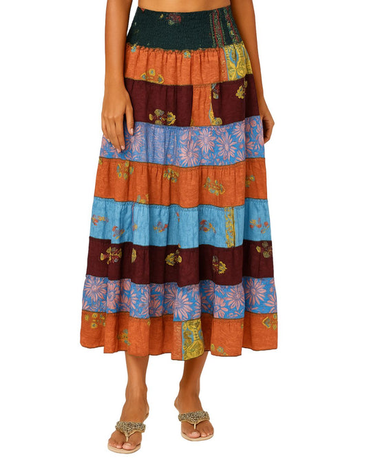 Multicolored patterned skirt worn by a person on a white background